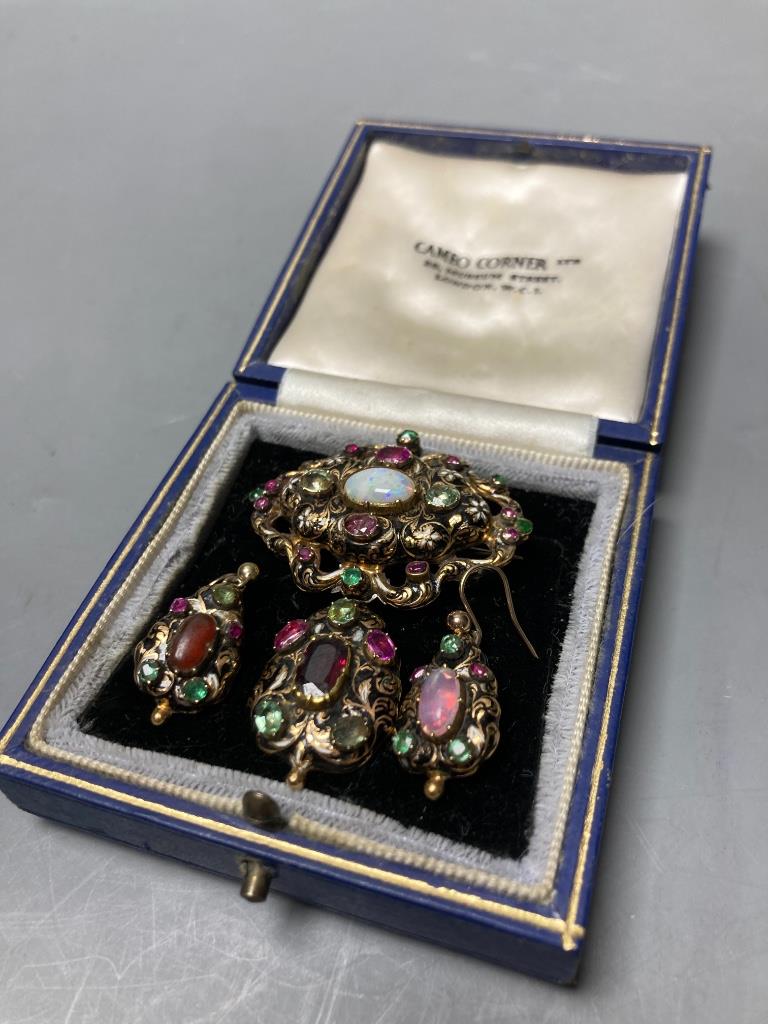 A Victorian yellow metal, enamel and multi gem set suite of jewellery (adapted), comprising a drop pendant brooch and pair of earrings